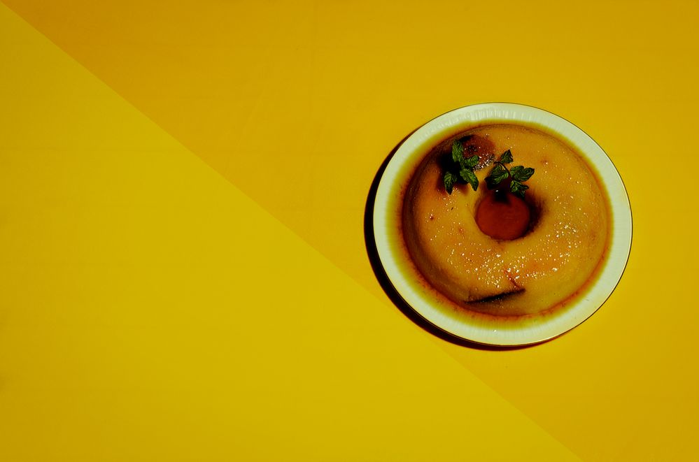 Dessert pudding on a two tone yellow background.jpg