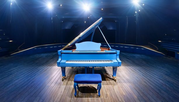 Firefly modern expensive sleek bright blue forte piano with piano bench on stage in concert hall wit.jpg